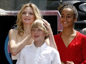 Actress Michelle Pfeiffer poses with her son John and daughter Claudia after Pfeiffer's star was unveiled on the Hollywood Walk of Fame on August 6, 2007. Pfeiffer adopted daughter Claudia before her marriage to writer David E. Kelley. REUTERS/Fred Prouser (UNITED STATES)